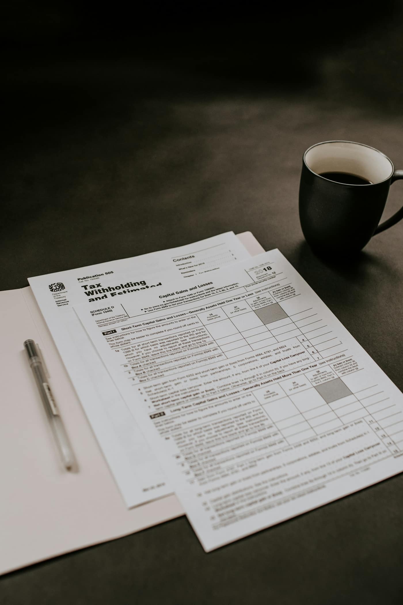 Invoice paperwork and coffee on a desk