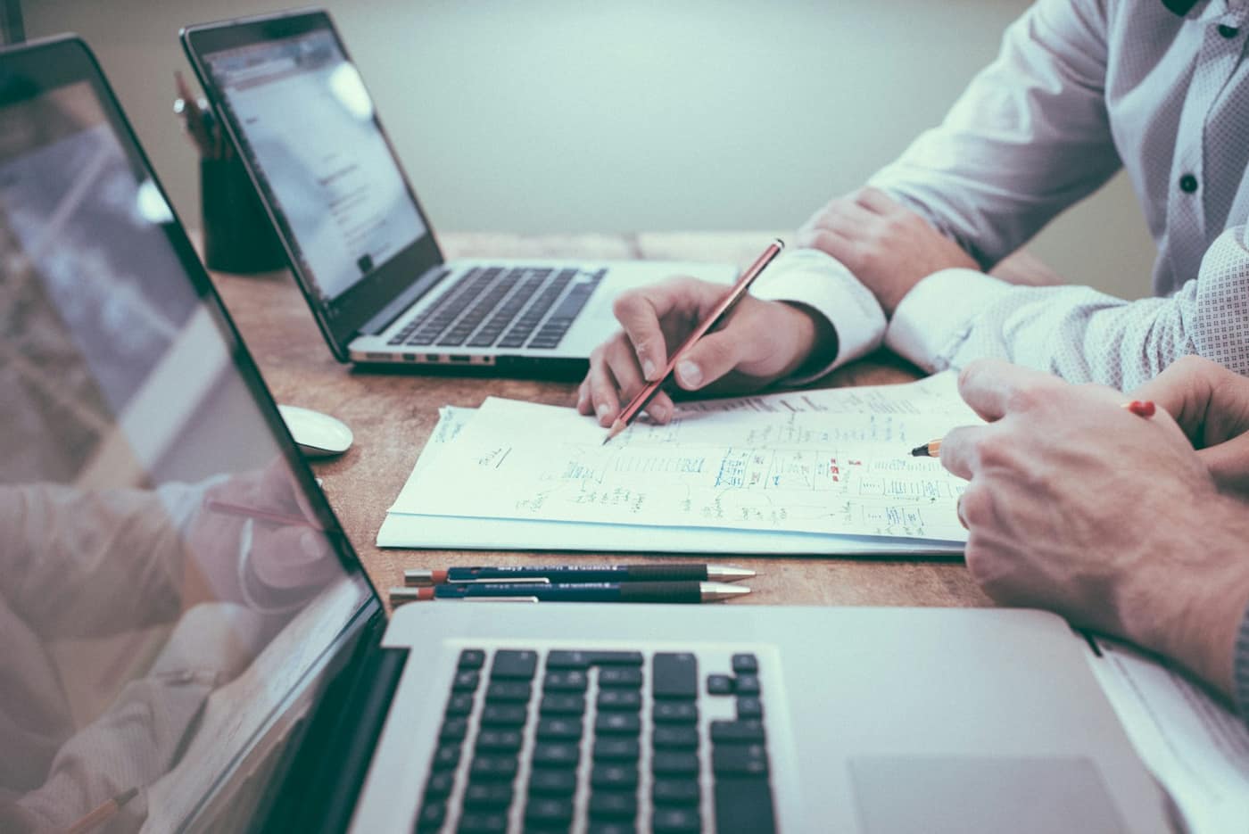 An accounting ledger and laptop on a desk