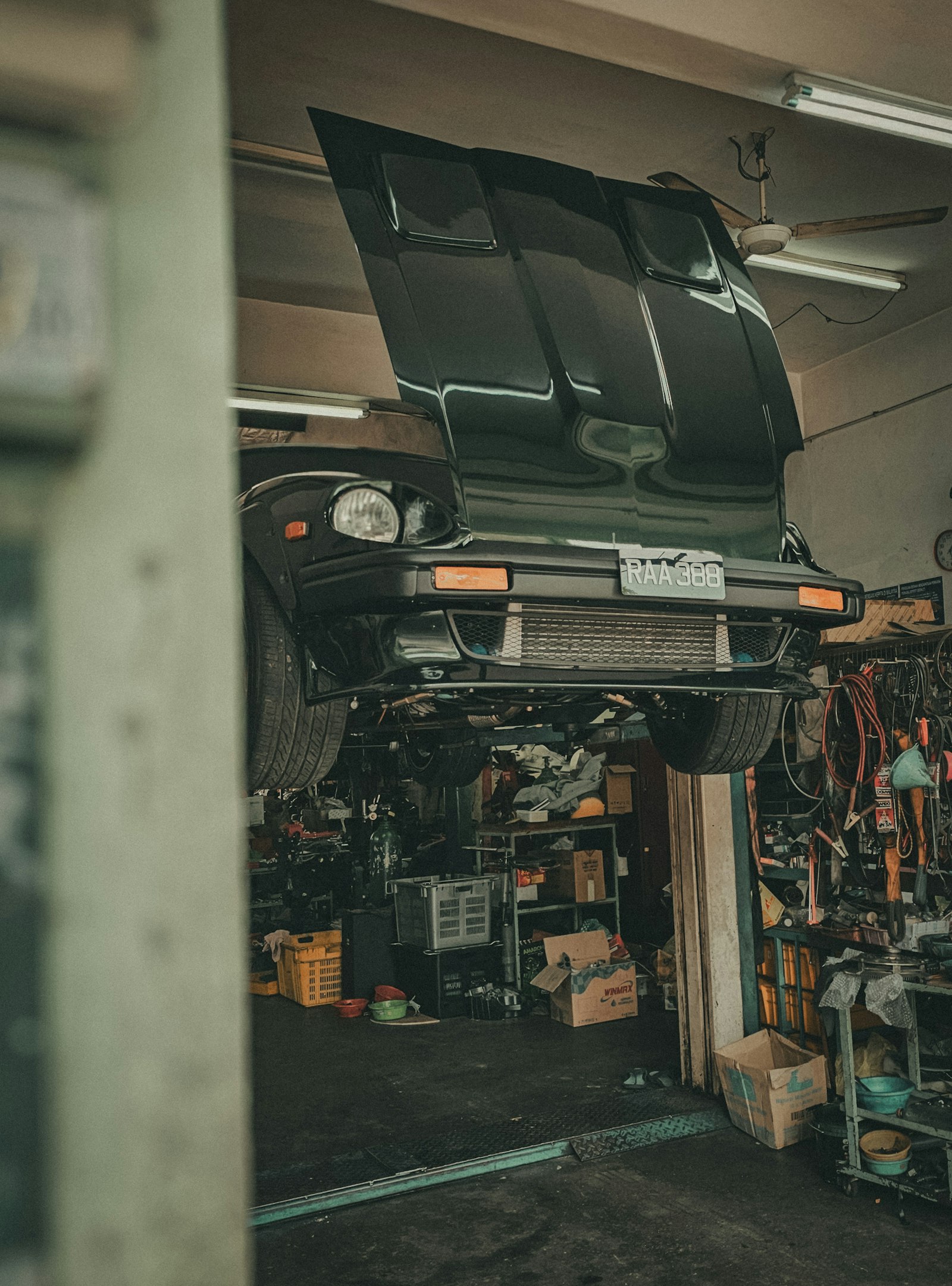 A car on a lift in an auto repair shop