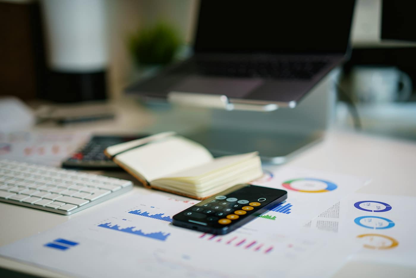 A bookkeeper's desk with a calculator and financial documents