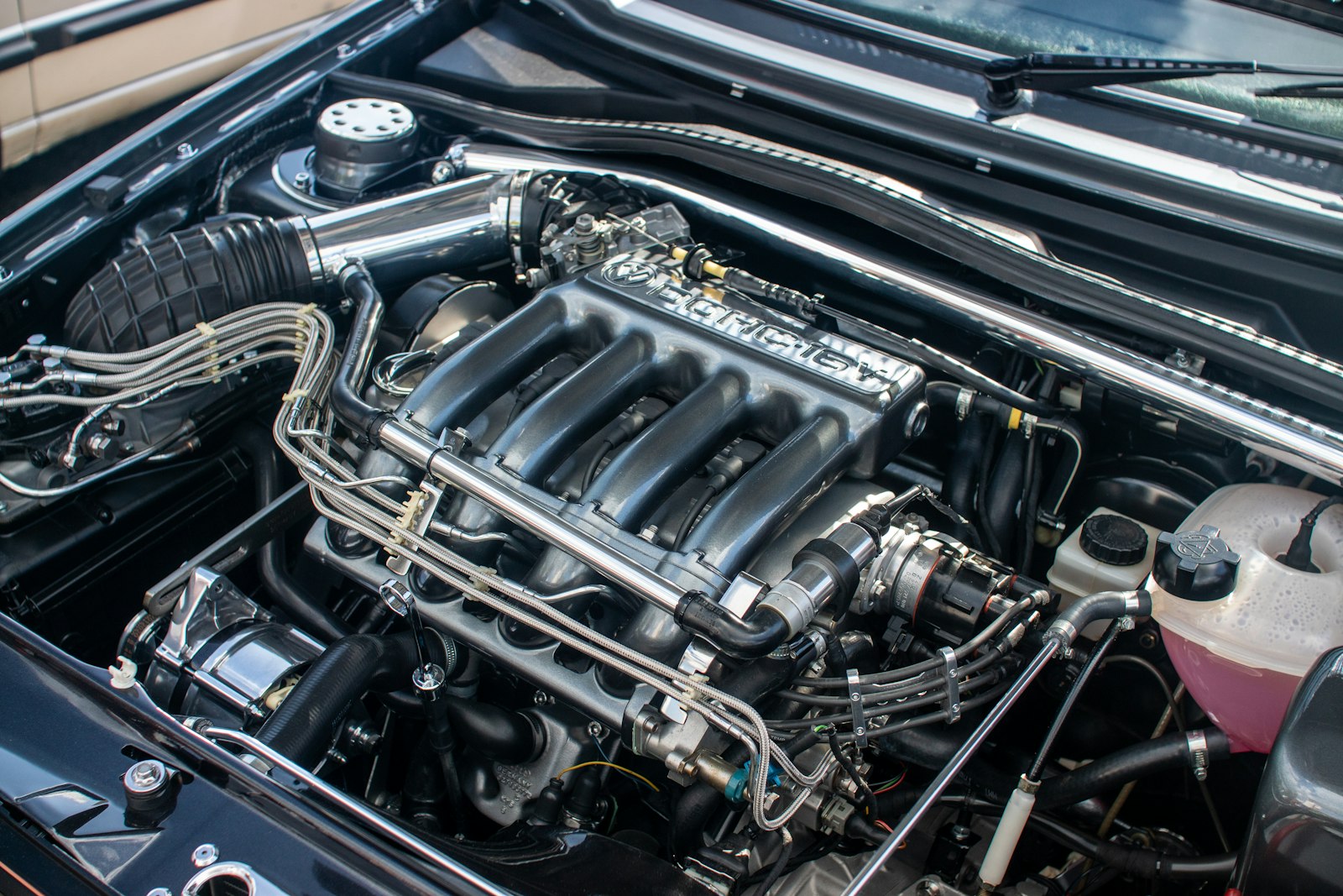 A car engine compartment with the hood up