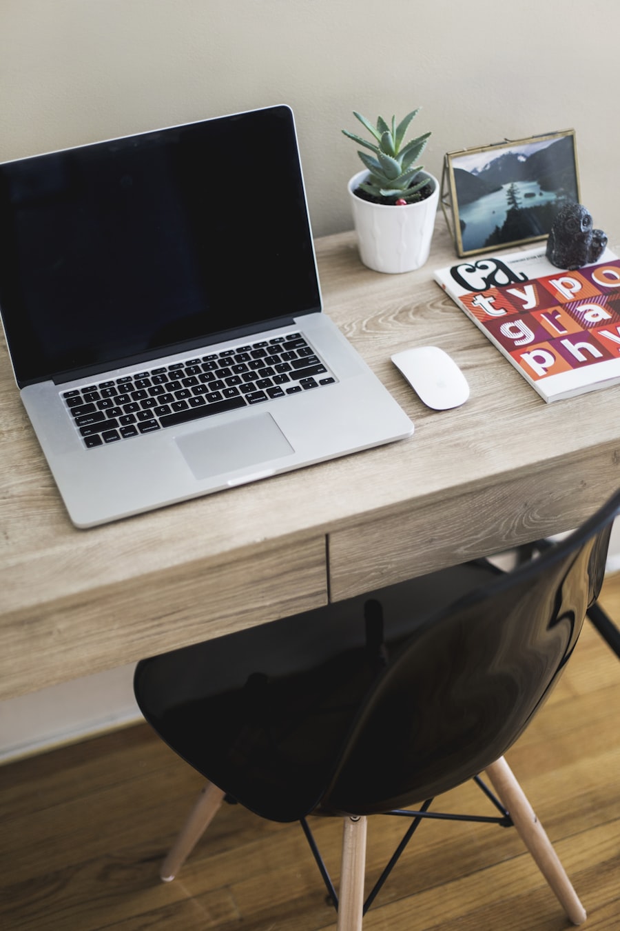 A clean consultant-style laptop and desk setup