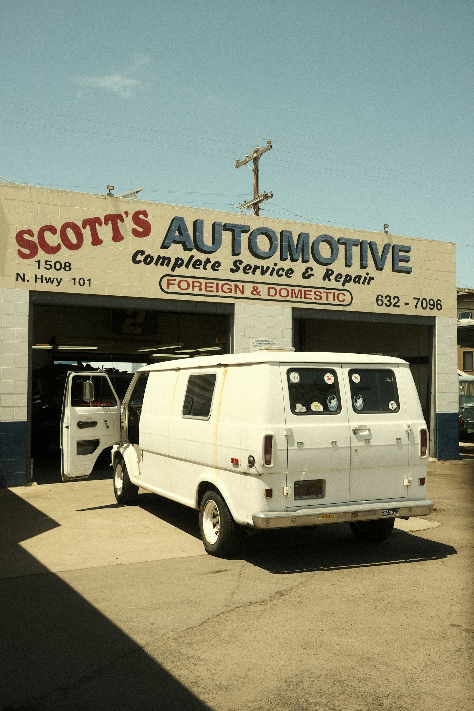 A white delivery van parked on the street