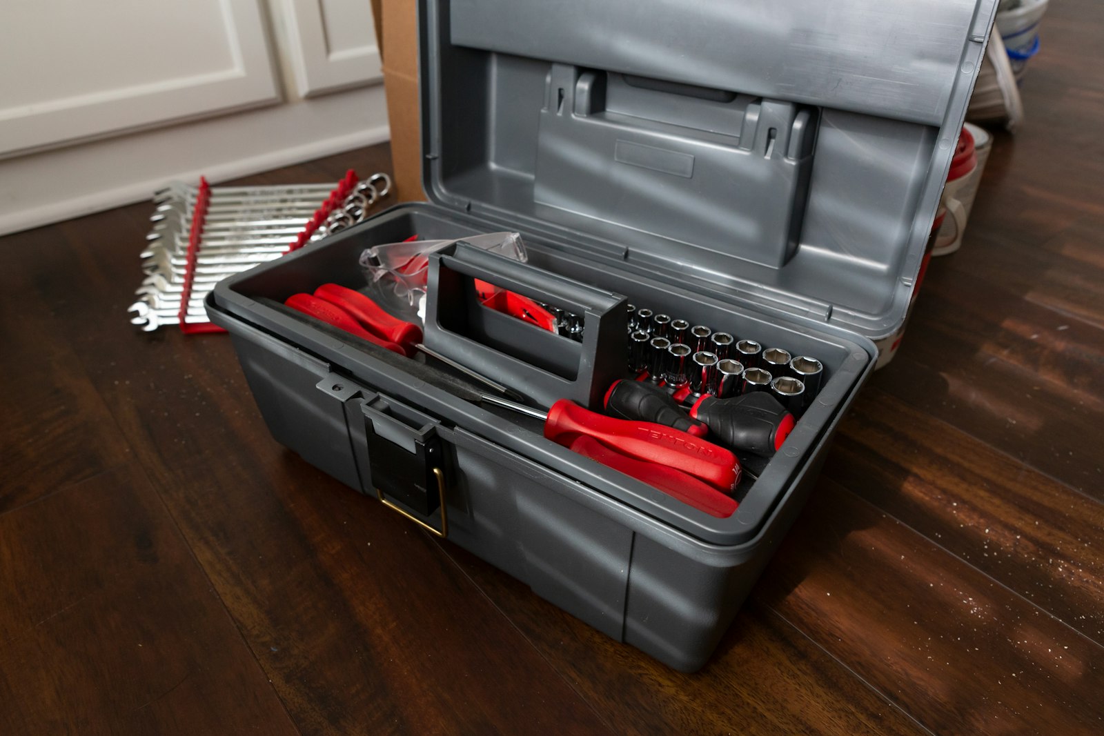 An open tool box with hand tools