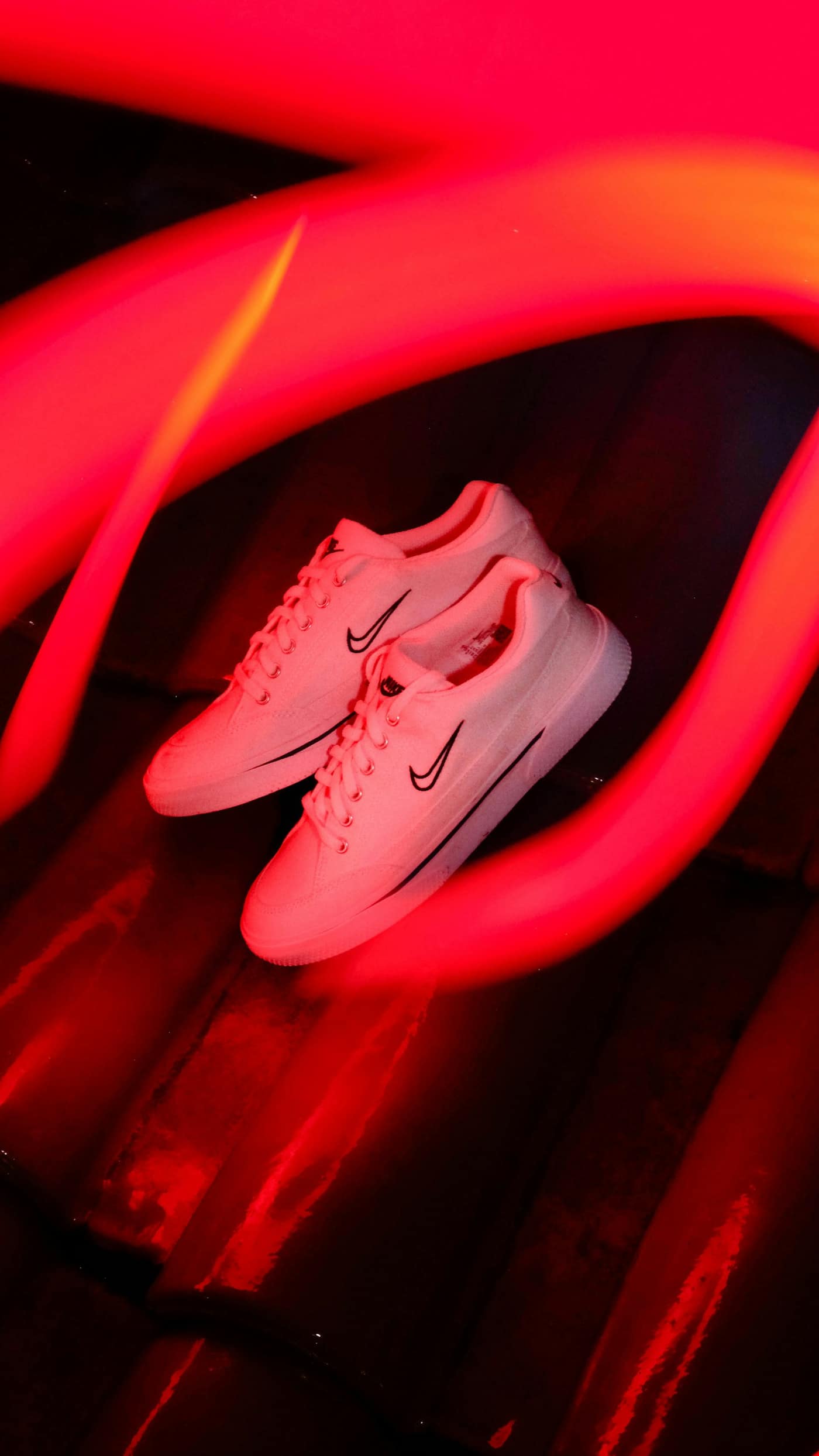 A pair of white trainers on a floor