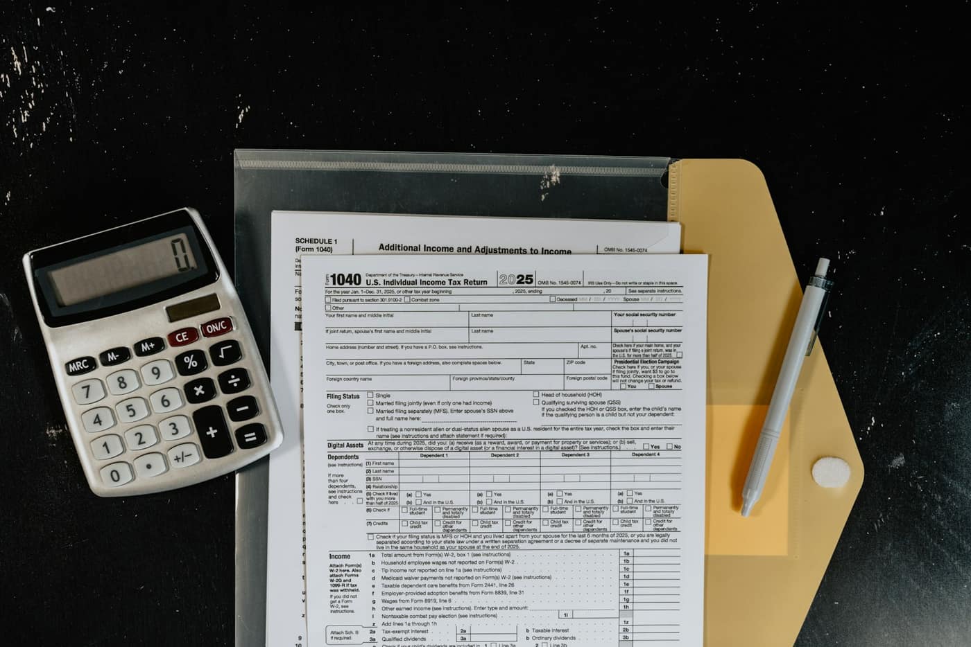 Tax paperwork and a calculator on a desk