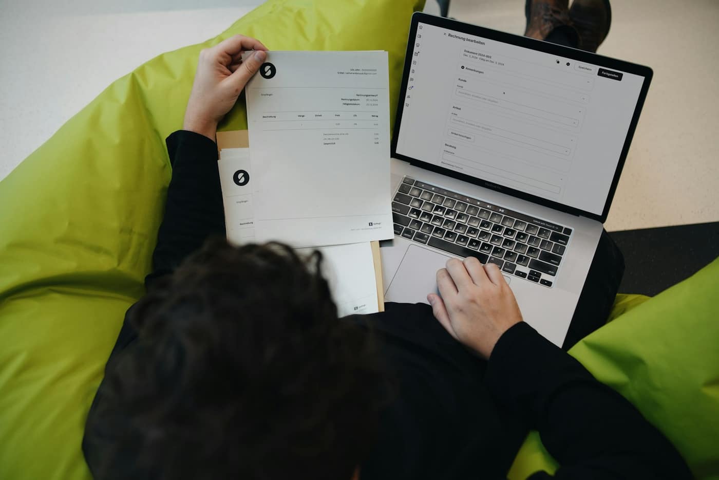 A person reviewing an invoice with figures