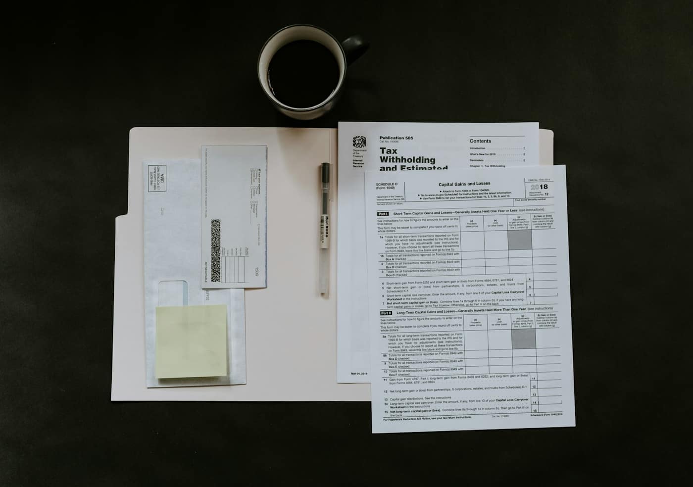 A desk with a calculator and tax paperwork