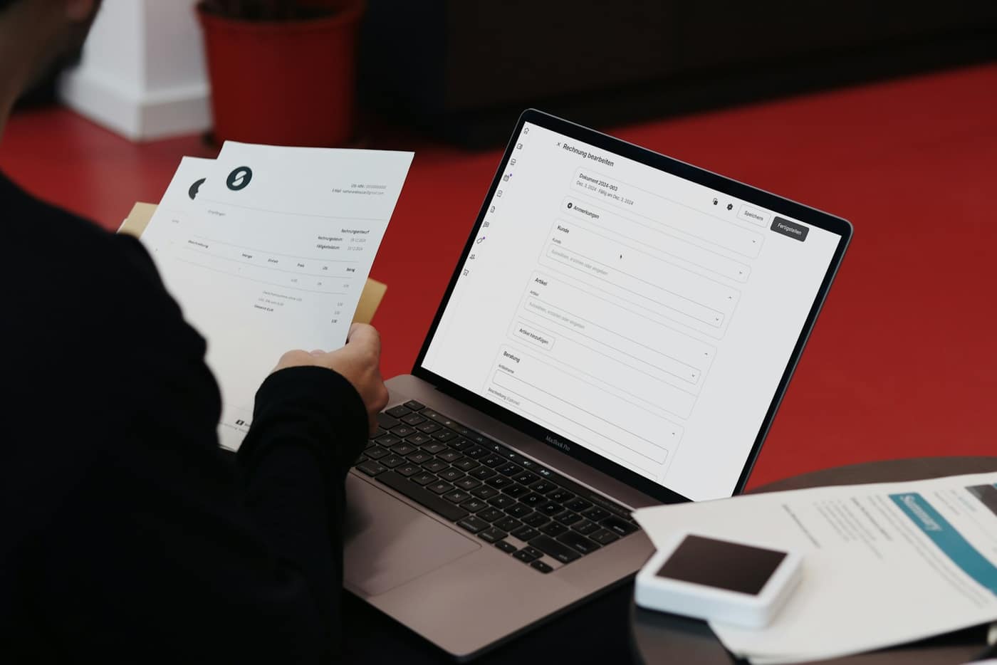 Tax documents and an invoice on a desk