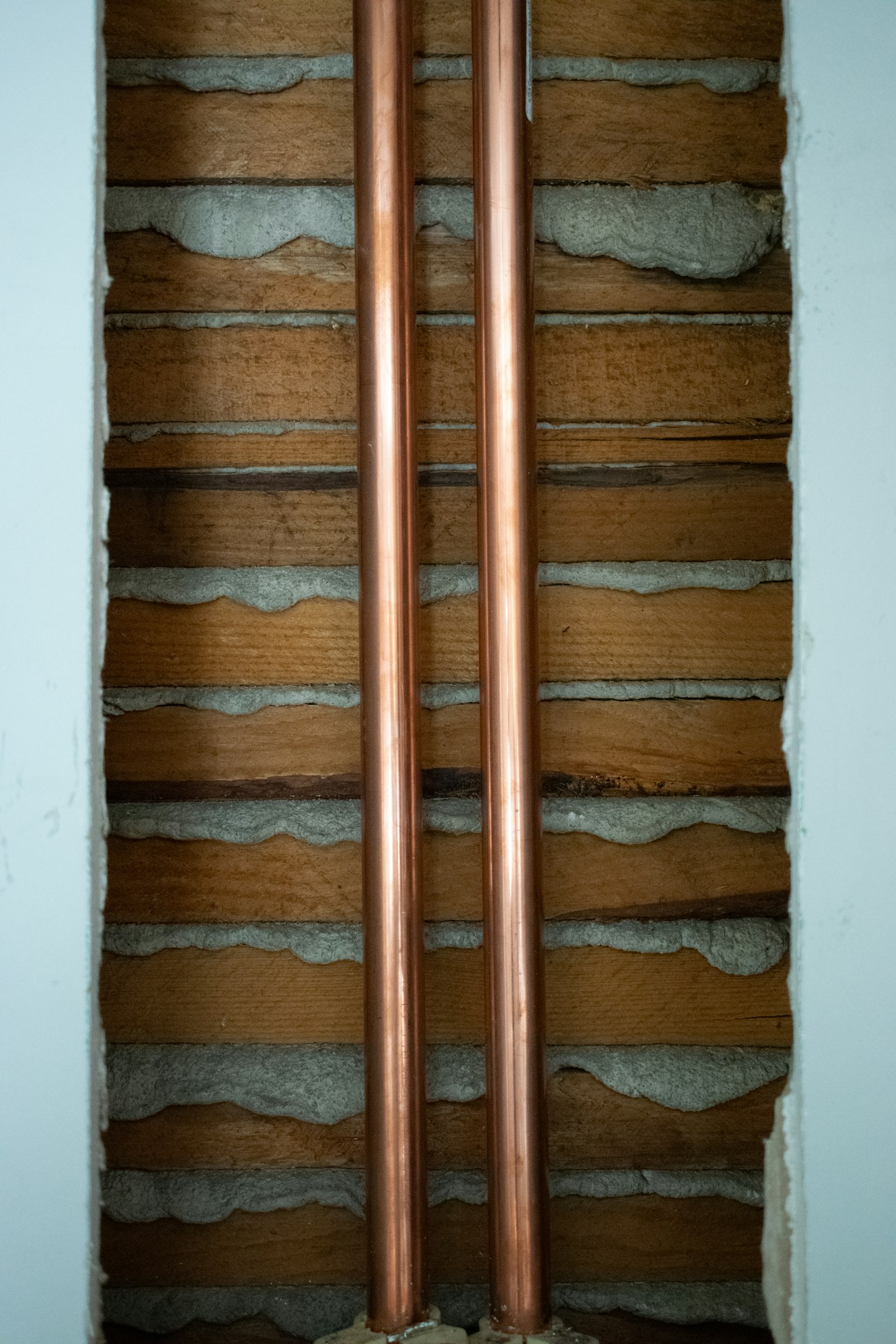 Copper plumbing pipes installed along a wall