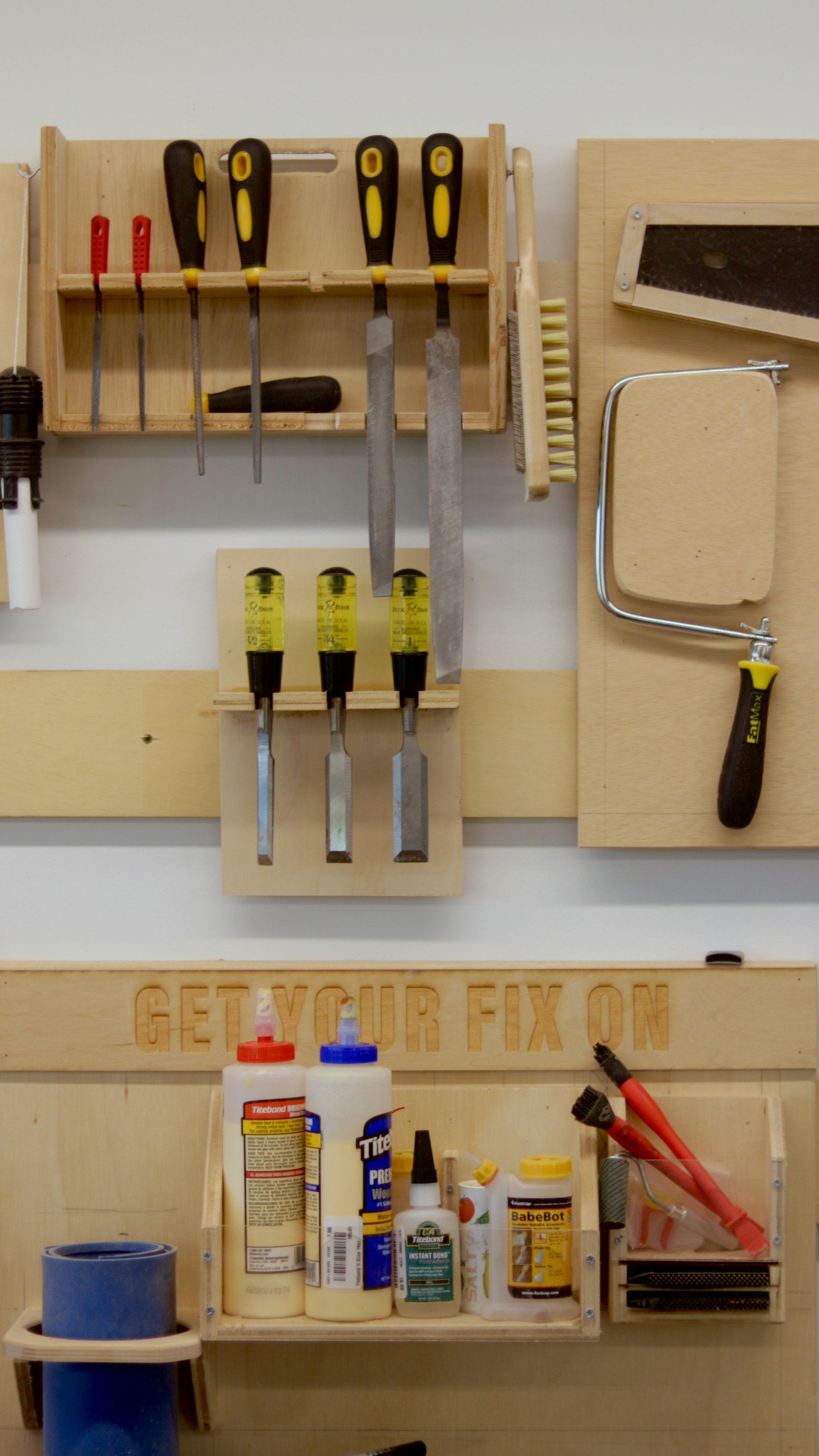 A workbench with plumbing and hand tools