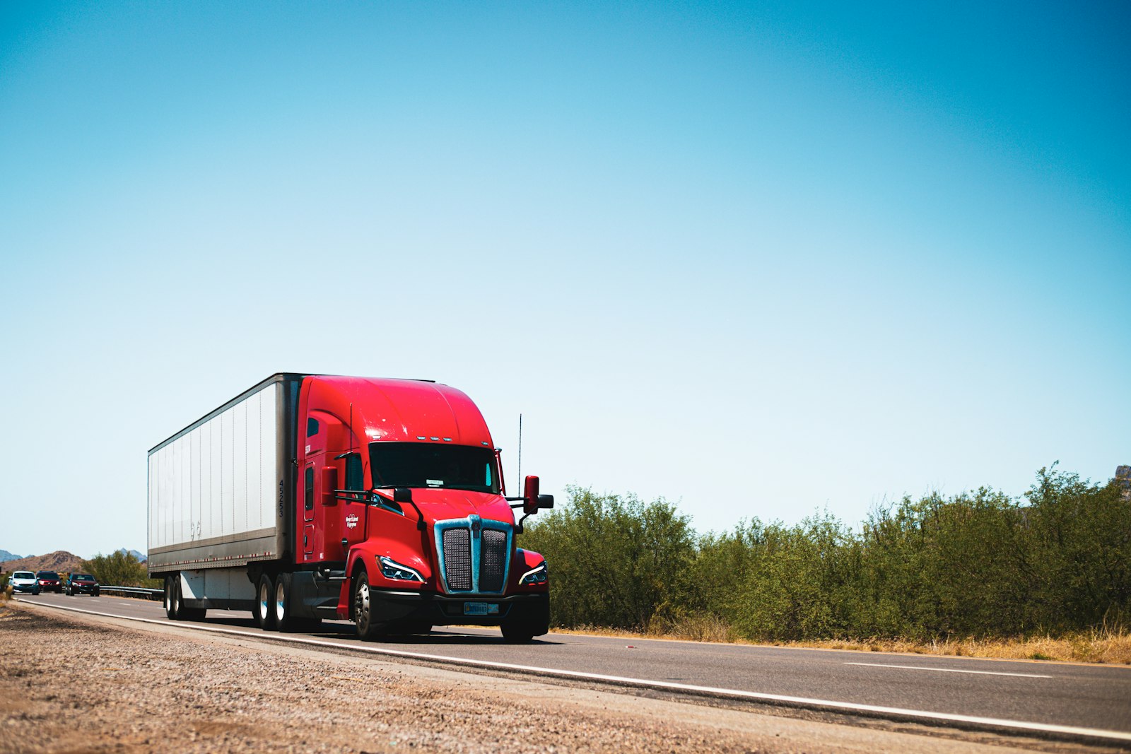 A red semi truck on the road