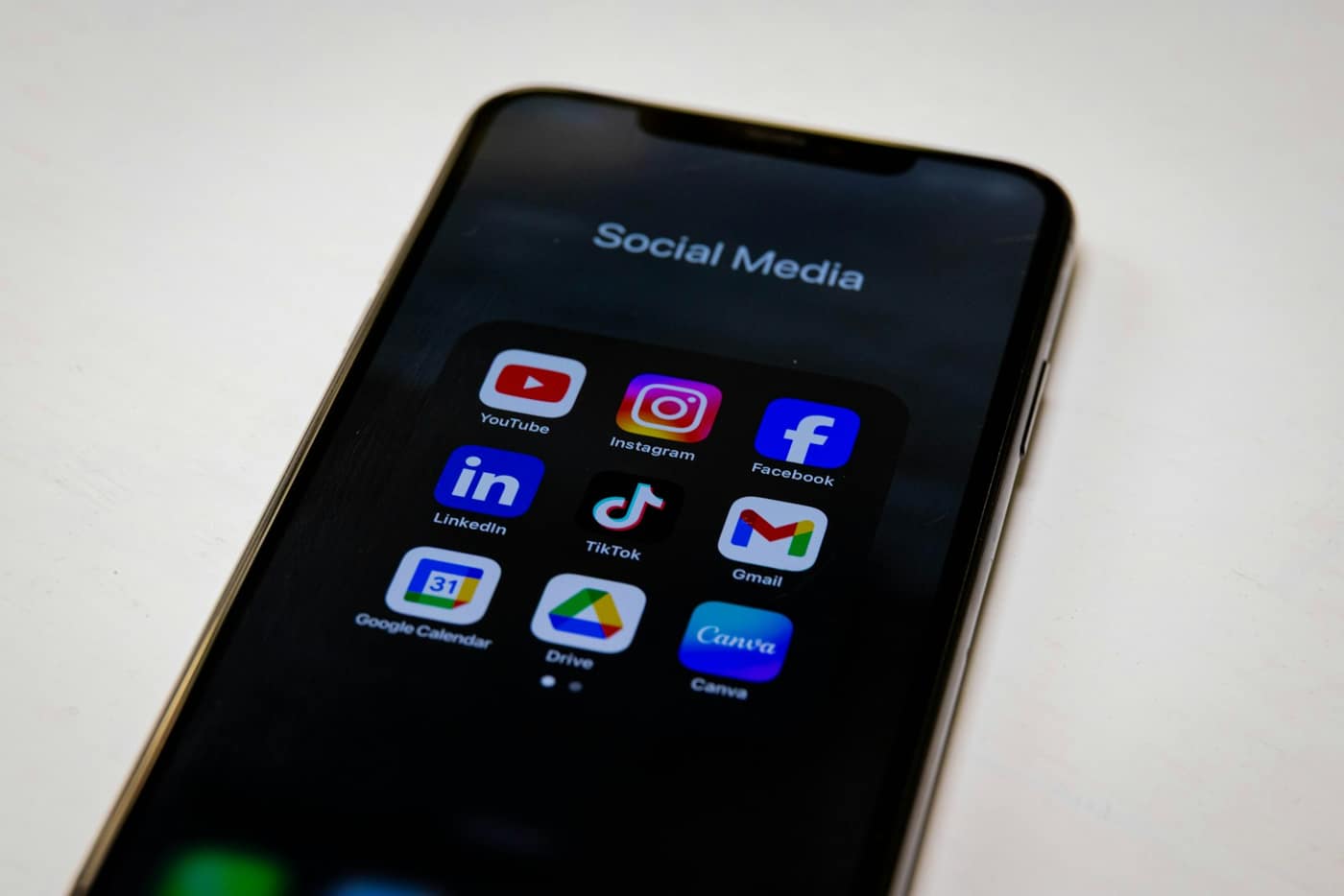 A phone showing social media apps on a desk
