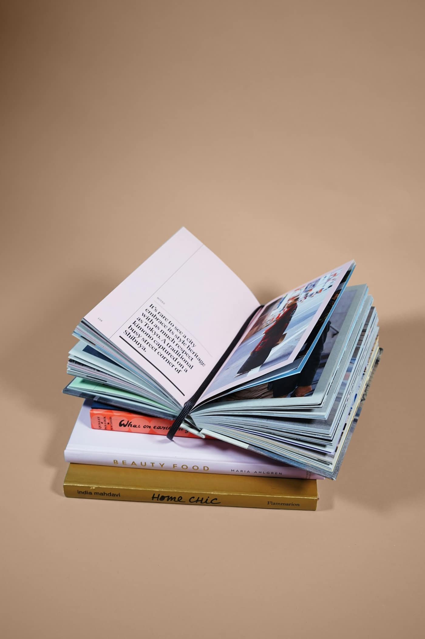 An open book on a stack of books