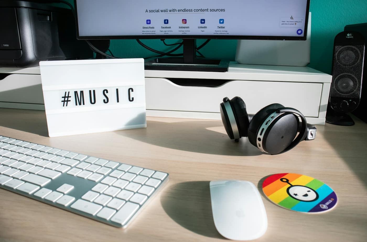 A desk with a keyboard, mouse and headphones