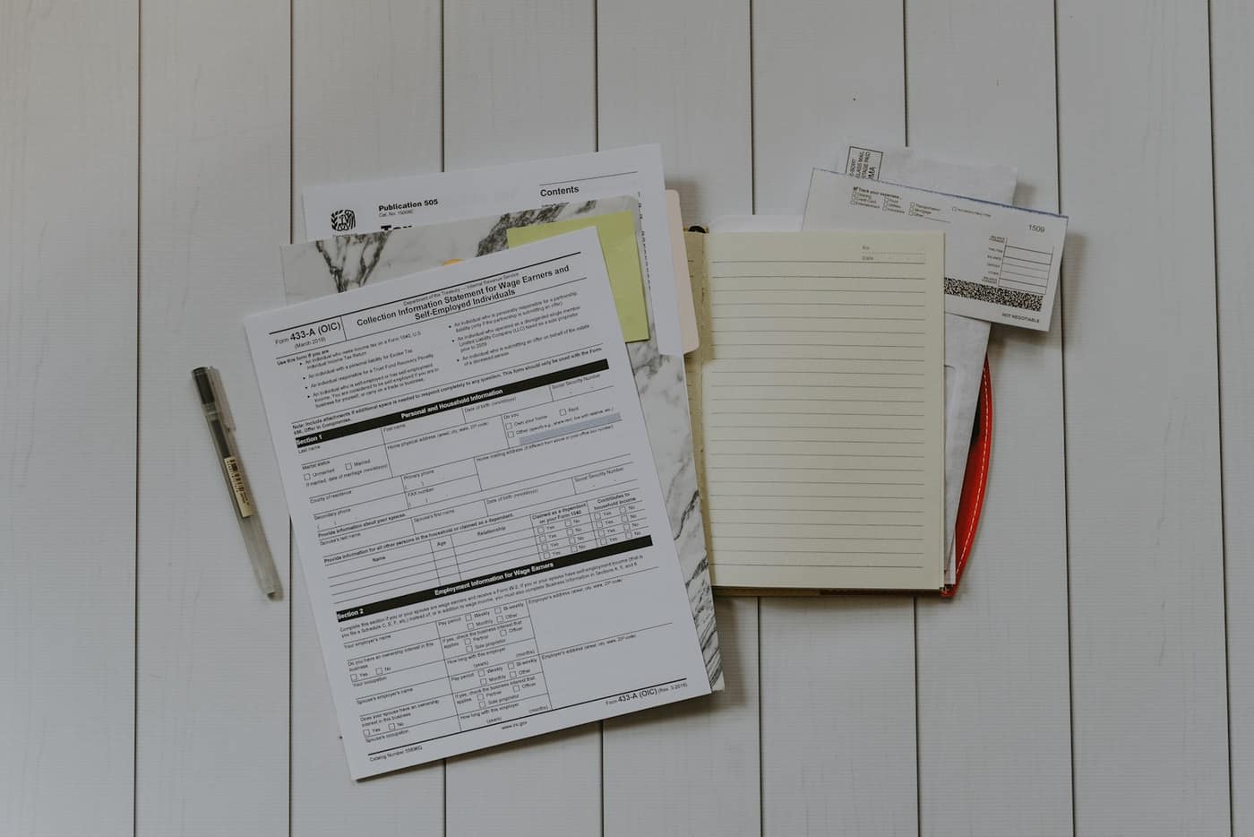 A UK business invoice and paperwork on a desk