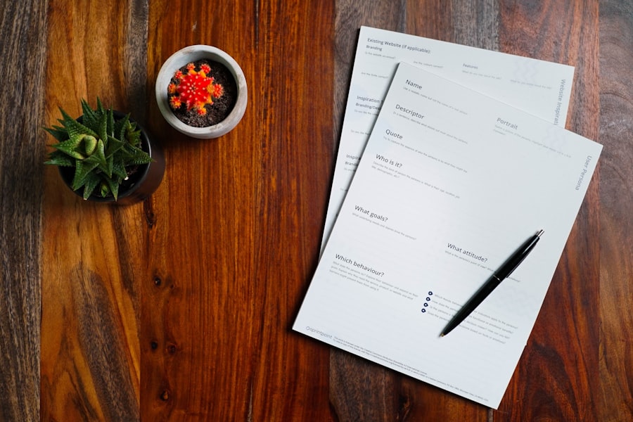 A wooden desk with financial documentation and a pen